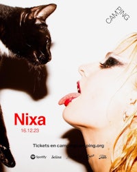 a woman is kissing a cat in front of a poster that says niqa