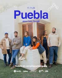 a group of people standing in front of a building with the words puebla